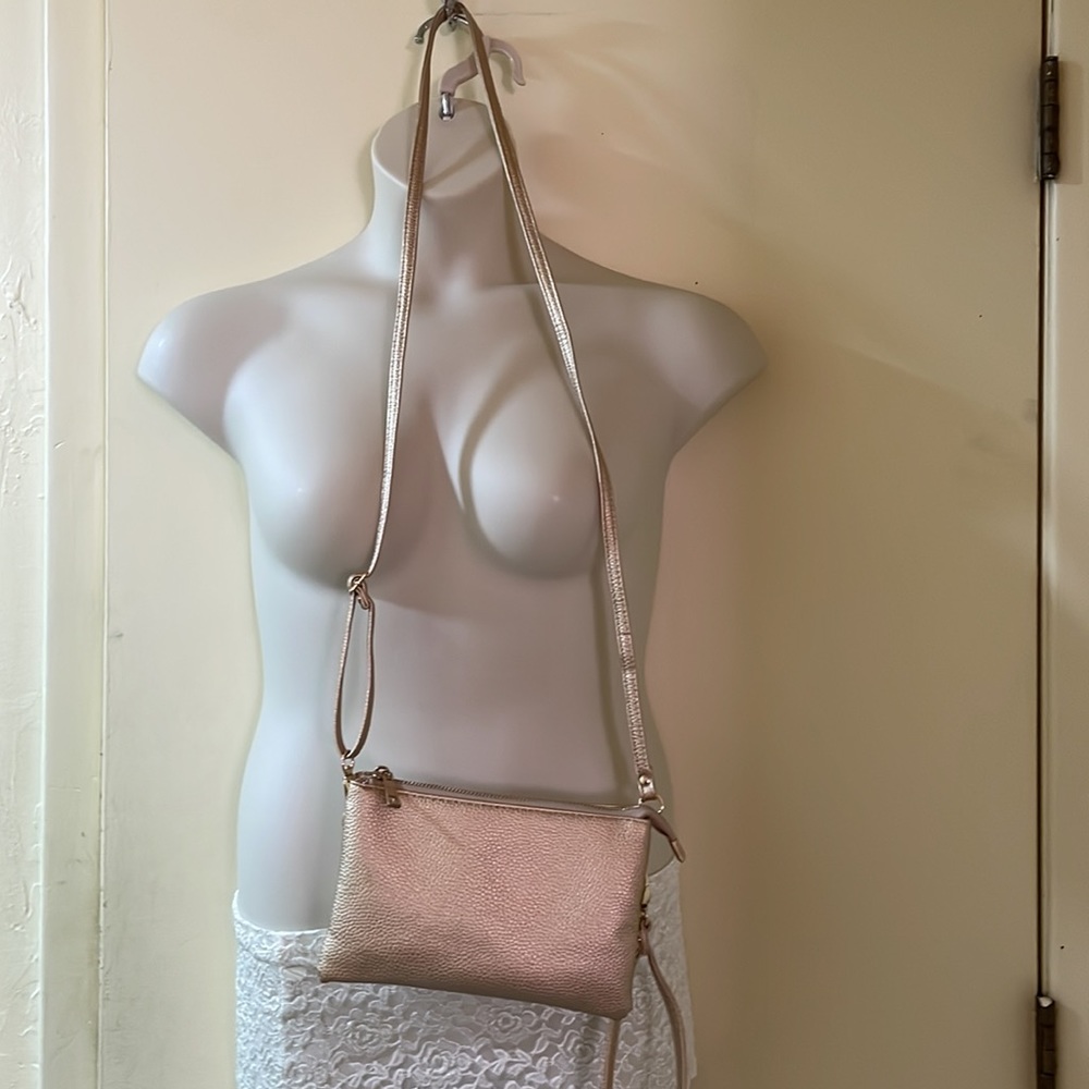 Rose gold wristlet purse never used.Paper removed from strap.Small for my needs.